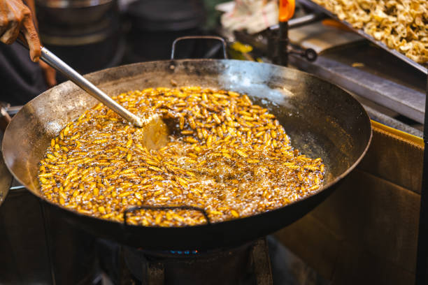 istock A man is cooking silkworms in deep fried. 2197165743