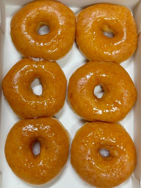 istock A classic glazed donut with a soft, fluffy texture and a sweet, glossy coating. Perfectly balanced between light and sugary, making it an irresistible treat for any time of the day. 2197169827