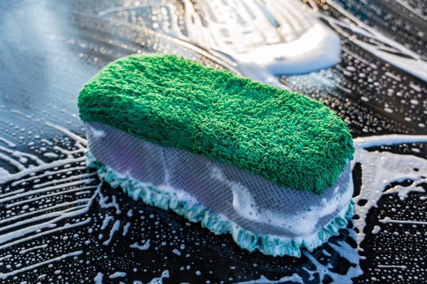 Close up of green microfiber car wash mitt with tendrils car wash detailing