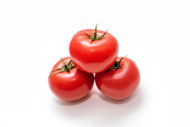 istock Three juicy tomatoes lie on a white isolated background 2197174380