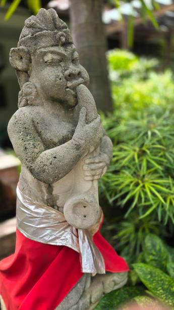 istock Garden Gnome traditional stone statue situated in a tranquil tropical garden, surrounded by vibrant foliage and artistic decor, harmonizing with the natural beauty of its environment 2197175422
