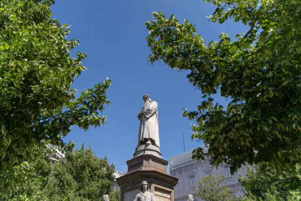 Pavia, Italy - February 22, 2019: car traffic around Statue of Minerva (Statua della Minerva) in Pavia city in morning. Minerva of Pavia was completed in 1938 by Italian sculptor Francesco Messina