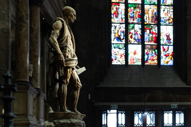 Milan Cathedral (Duomo di Milano) and Vittorio Emanuele II statue, Italy. Silhouette backlit.