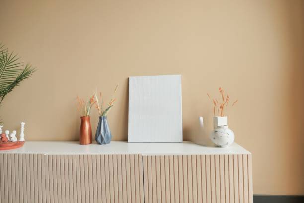 istock This stylish interior has elegant vases, soothing neutral tones, and a creative blank canvas. 2197177431