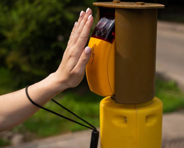 istock Close-up of a blind woman's hand pressing a button for a traffic light. 2197178918