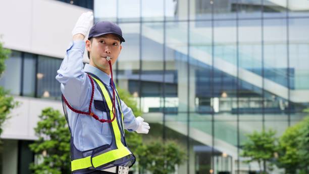 Asian traffic controller directing traffic stock photo