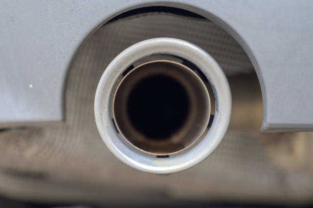 A detailed close-up of a car's exhaust pipe, highlighting its circular structure and metallic texture.