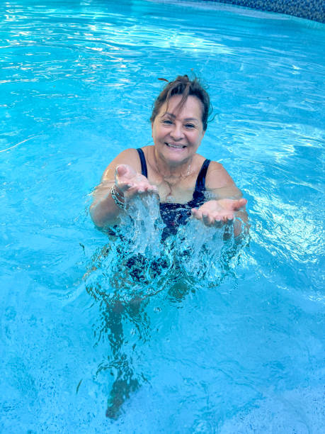 istock Attractive Hispanic senior woman in pool 2197180614