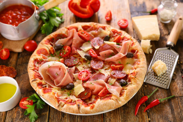 istock pizza with tomato sauce, prosciutto ham, olive and mozzarella 2197182584