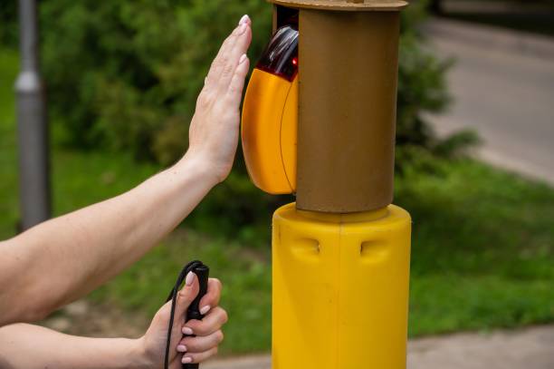 istock Close-up of a blind woman's hand pressing a button for a traffic light. 2197186036