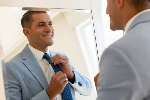 istock Male getting dressed in front of mirror 2197191735