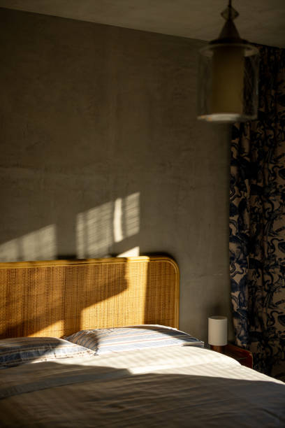 istock Sunlit Bedroom with Rattan Headboard 2197191829