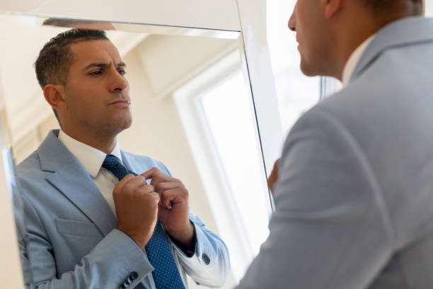 istock Male getting dressed in front of mirror 2197191979