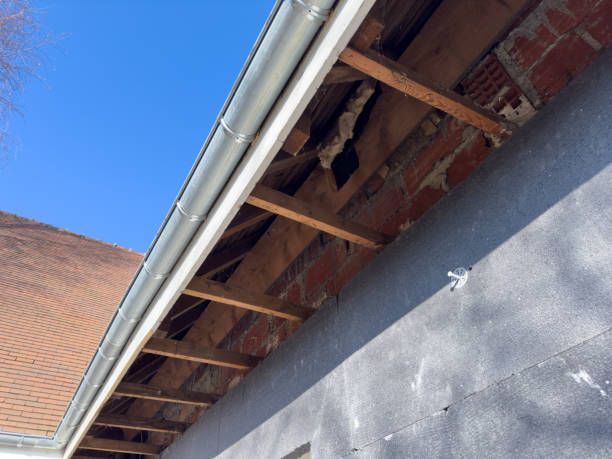 istock Home renovation reveals open roof structure under a clear blue sky 2197191985