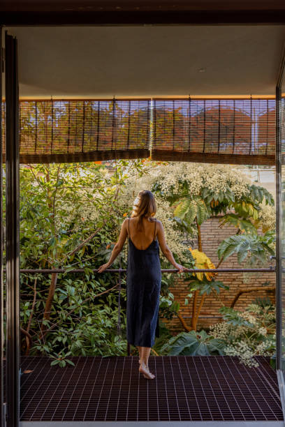 istock Woman Enjoying Nature on a Modern Balcony 2197193711