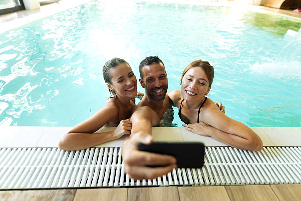 istock Friends having fun at the indoor pool 2197197106