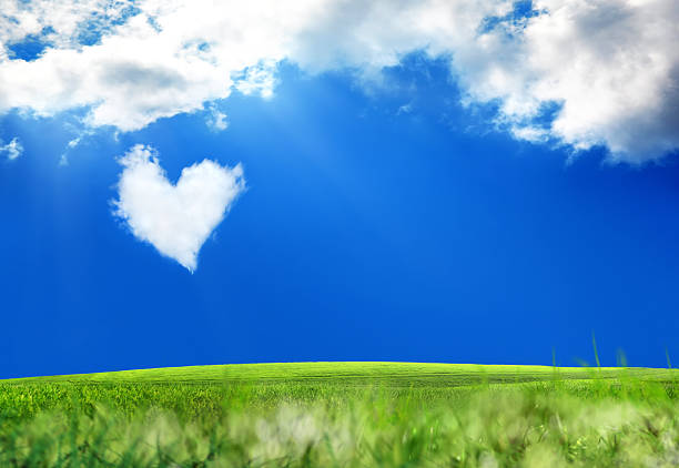 Conceptual sky background with heart shaped cloud