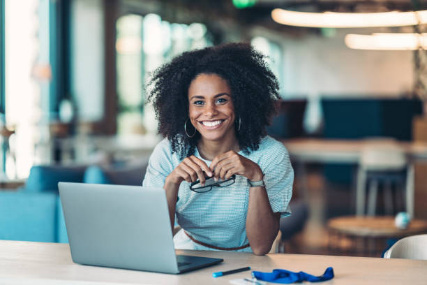 istock Cheerful young businesswoman working in a modern office space 2197200081