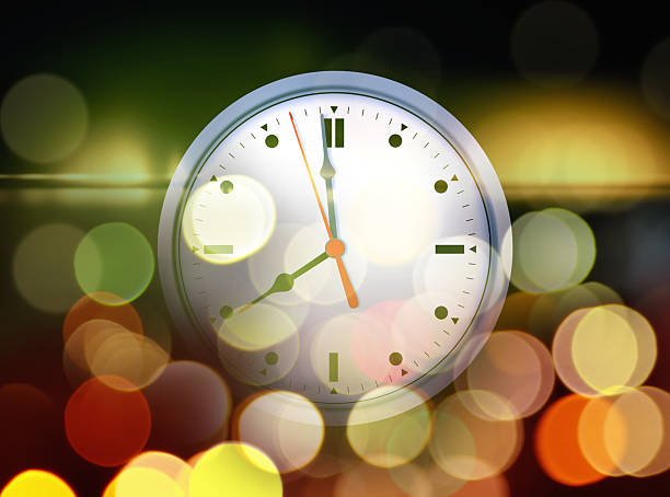 istock Close up clock face in glowing abstract lights 2197200173