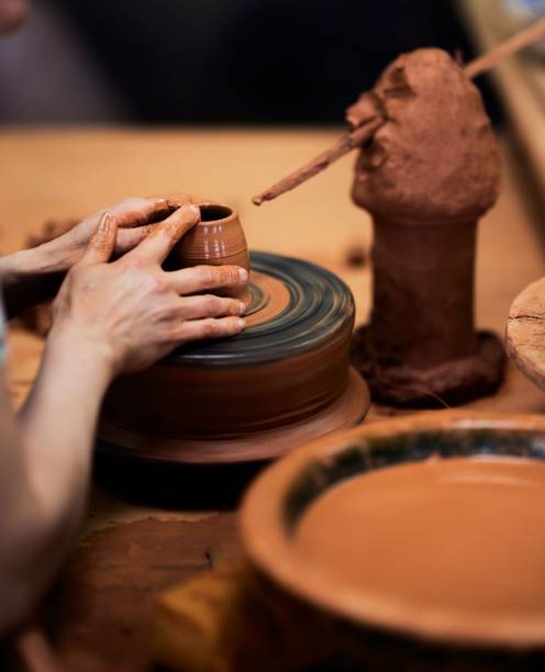 istock Hands shaping clay on a pottery wheel. 2197204124