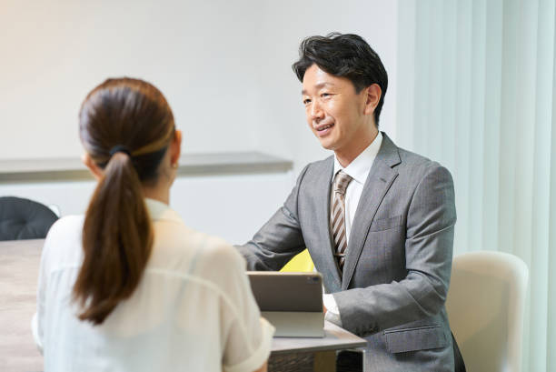 istock A man in a suit talking to a woman 2197204787