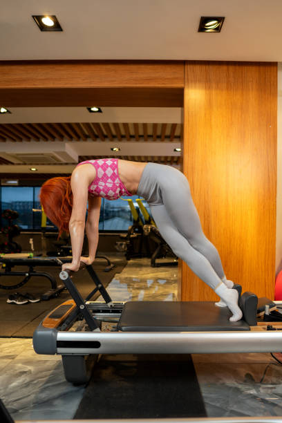 istock Woman exercising on pilates machine 2197205339