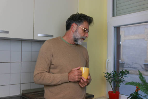 istock Senior man drink coffee in kitchen 2197205479