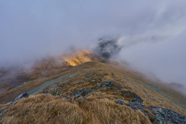 Landscape with rocky mountains and hiking trails in a cold November day