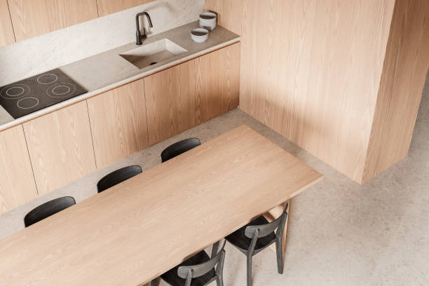 istock Modern kitchen interior design with wooden cabinets, dining table, and minimalist decor. 3D Rendering 2197207684