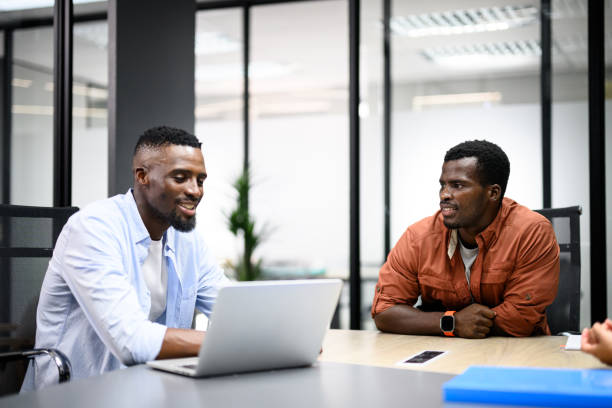 istock Young man sitting in meeting with colleagues 2197207724