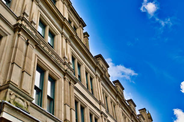 istock Multi-Story Building Facade Against Blue Sky  in Manchester, UK. 2197209195