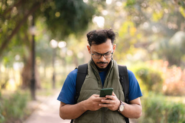 istock Young man using his mobile phone outdoors 2197212349