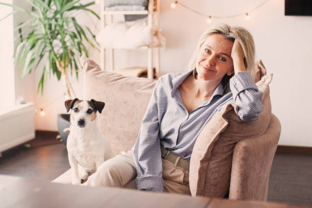 istock Cut Middle aged Woman sitting on couch at home 2197212440