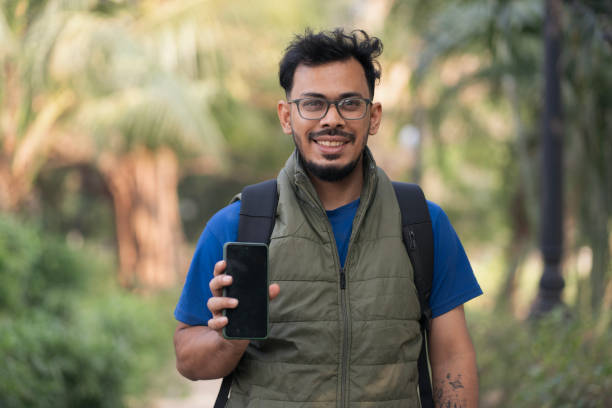 istock Cheerful young male showing his smartphone screen 2197212492