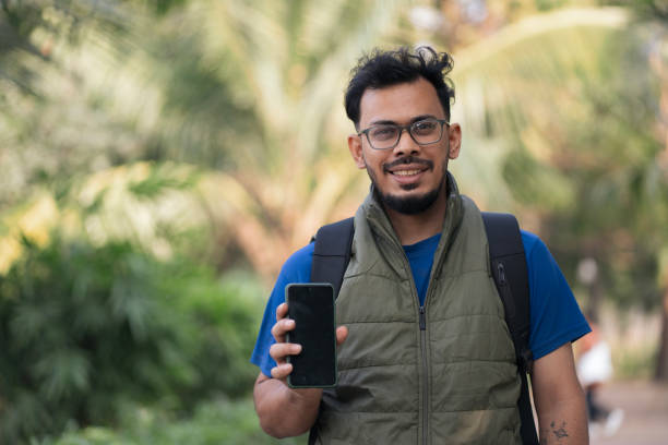 istock Cheerful young male showing his smartphone screen 2197212548