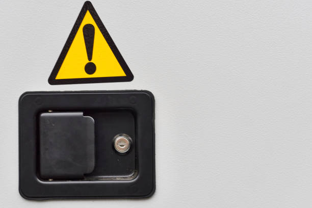 istock Metal doors with a lock, electric shock hazard sign zone 2197213609