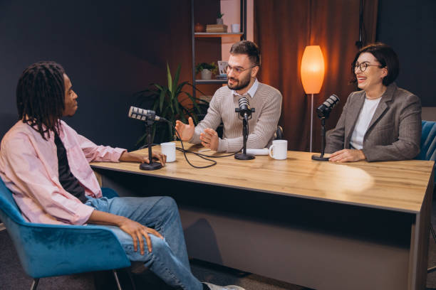 istock Content creators recording a podcast episode in a professional studio, discussing and sharing their insights 2197215560