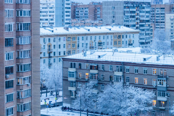 Snowfall in the city. Snow falling on roof top. Winter Kyiv landmark. Frosty winter weather. Snowfall in downtown district. Snow and wind. Buildings and street covered with snow. Christmas weather.
