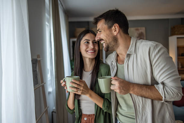 istock A couple drinks morning coffee and enjoys their new apartment 2197219953