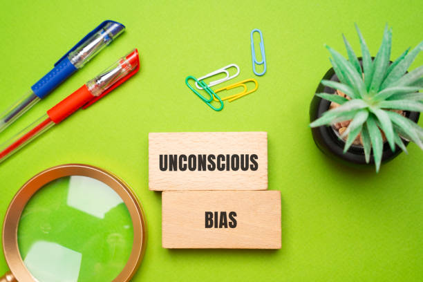 istock Unconscious bias concept - attitudes or stereotypes that affect our understanding, actions, and decisions in an unconscious manner. Implicit bias. Social norms or cultural influences. Wooden blocks 2197220014