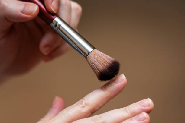 istock women's hands using a soft brush to gently clean nails and fingers from cuticle and skin remnants after a manicure procedure, highlighting nail care and beauty 2197223821