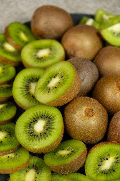 istock Fresh kiwi fruit, many whole and sliced kiwi 2197224584