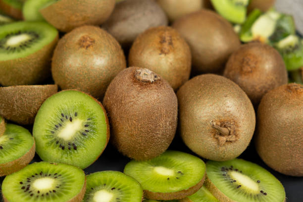 Plate of sliced and whole fresh kiwi fruit