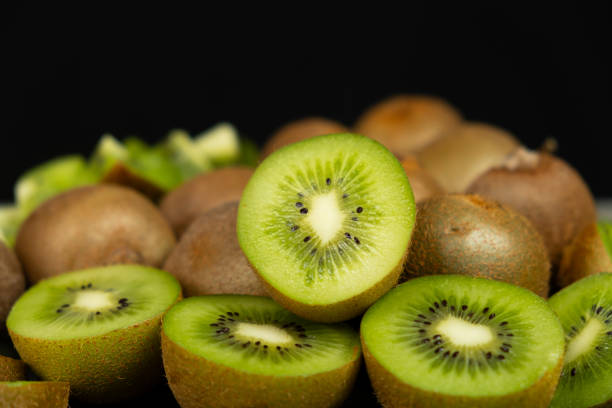 istock Fresh kiwi fruit, many whole and sliced kiwi 2197224606