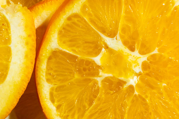 istock Orange background, ripe oranges cut into slices close-up. 2197224709