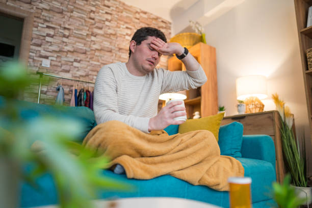 istock Sick At Home . Man having a cup of tea 2197224942