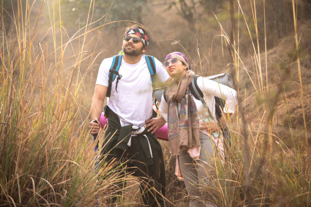 istock Tired young couple standing and resting in forest 2197227033