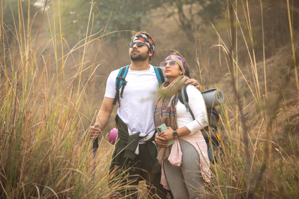 istock Young couple in sunglasses standing in forest 2197227090
