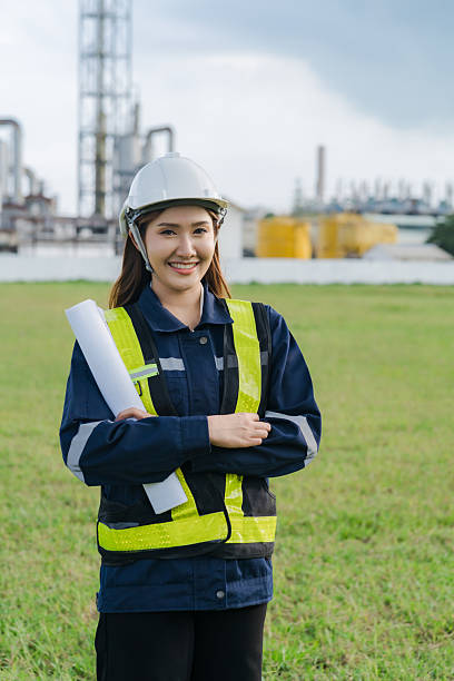 istock Female engineer surveys construction site. Engineer works outdoors next to power plant 2197227159