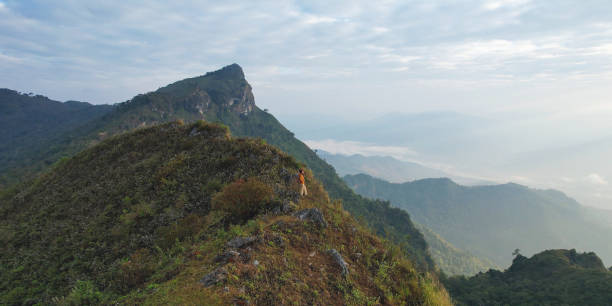 istock A woman standing on the mountain peak 2197228836
